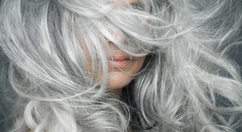 woman-with-grey-hair-blowing-across-her-face